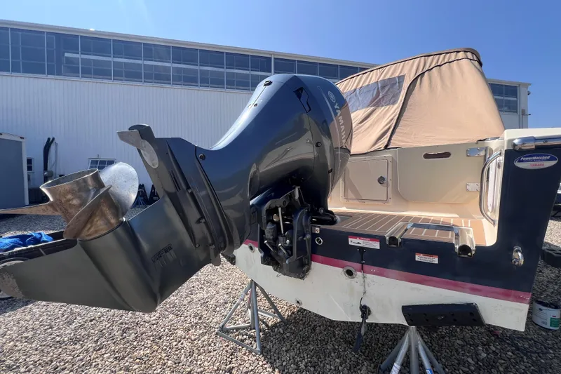 Slide: The Image of 2018 Rossiter 23 boat with Yamaha outboard motor, docked outdoors under clear sky. - 3
