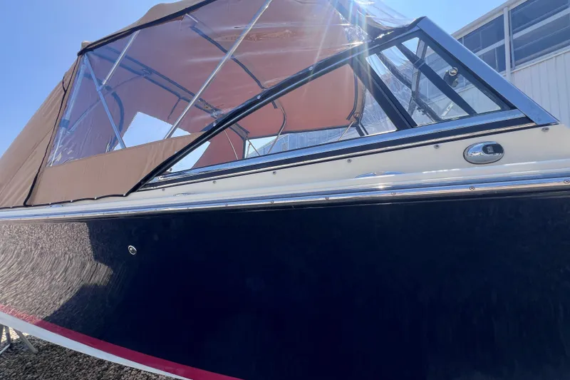 Slide: The Image of 2018 Rossiter 23 boat with tan canopy and sleek black hull. - 33