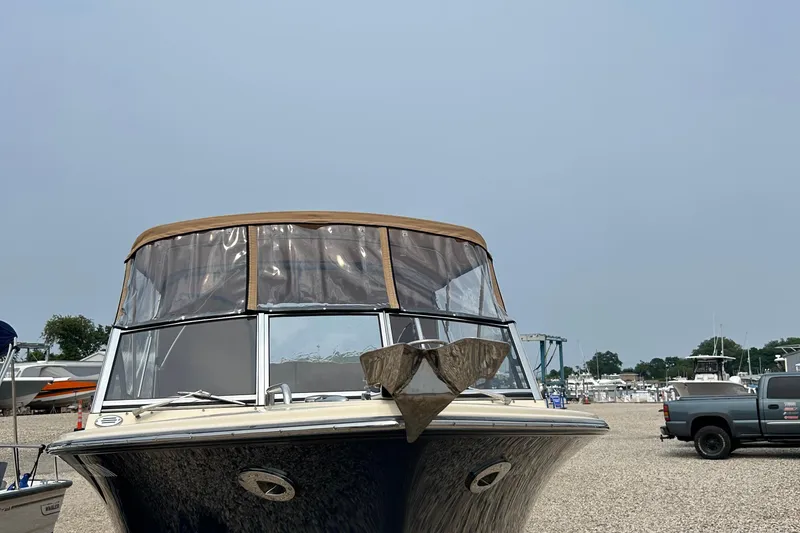 Slide: The Image of 2018 Rossiter 23 boat with brown canopy, parked on gravel near other vehicles and boats. - 35