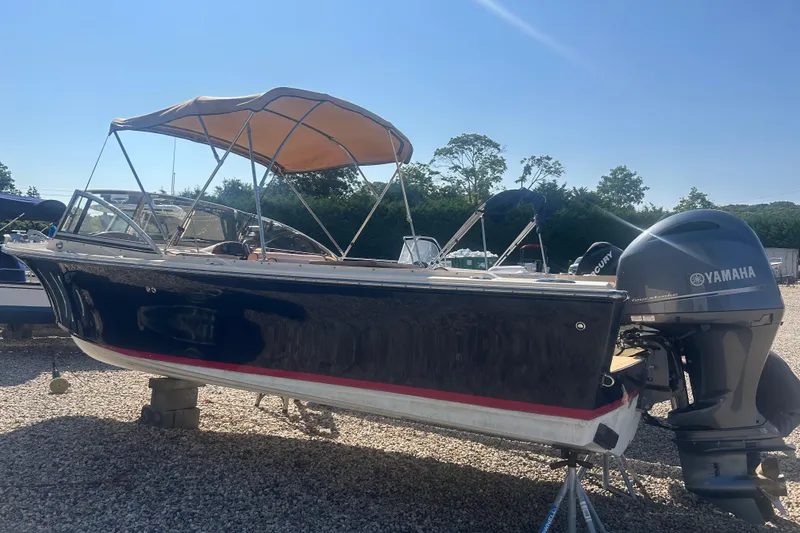 Slide: The Image of 2018 Rossiter 23 boat with Yamaha outboard motor, parked on gravel. - 36