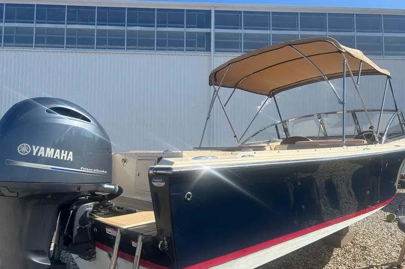 Slide: The Image of 2018 Rossiter 23 boat with Yamaha outboard motor, parked outdoors. - 37
