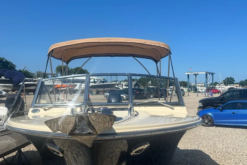 Slide: The Image of 2018 Rossiter 23 boat with canopy in a marina parking area. - 38