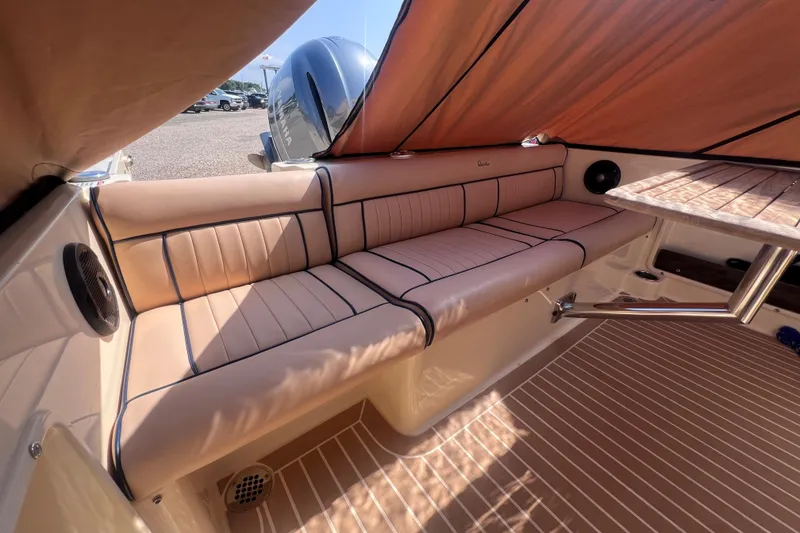 Slide: The Image of Luxurious interior of 2018 Rossiter 23 boat with cushioned seating and wooden table. - 8