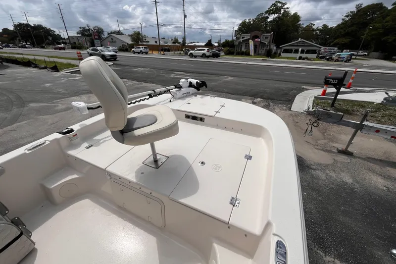 Slide: The Image of 2024 Carolina Skiff 21 LS boat with swivel seat, parked near a road. - 12