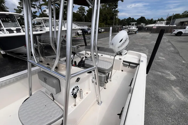 Slide: The Image of 2024 Carolina Skiff 21 LS boat interior with seating and Suzuki outboard motor. - 16