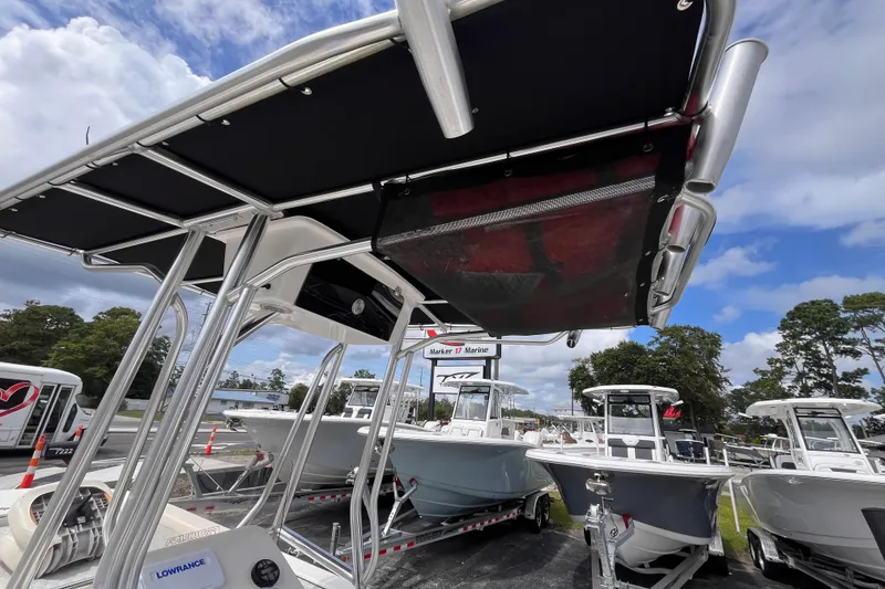 Slide: The Image of 2024 Carolina Skiff 21 LS boats displayed outdoors under a blue sky. - 18