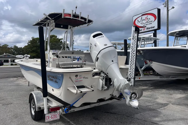 Slide: The Image of 2024 Carolina Skiff 21 LS boat on trailer, displayed at Marker 17 Marine dealership. - 2