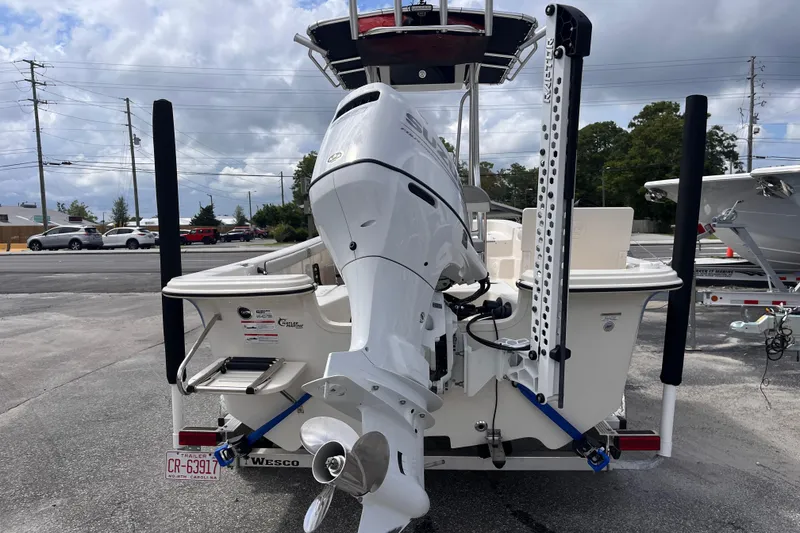 Slide: The Image of 2024 Carolina Skiff 21 LS boat with outboard motor, parked on a trailer. - 3