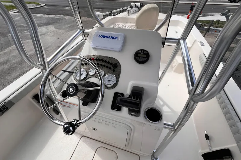 Slide: The Image of 2024 Carolina Skiff 21 LS boat console with steering wheel and navigation equipment. - 9