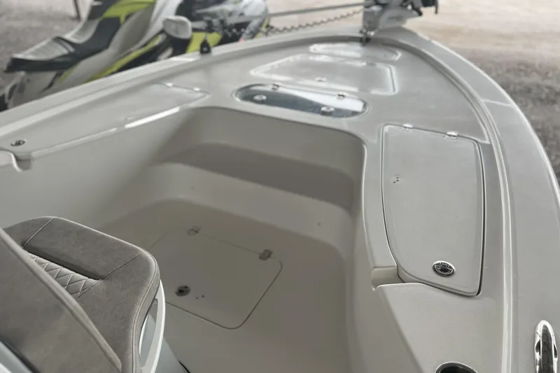 Slide: The Image of 2023 Sea Pro 248 Bay boat interior with seating and storage compartments. - 12