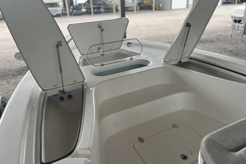 Slide: The Image of 2023 Sea Pro 248 Bay boat interior with open storage compartments. - 13