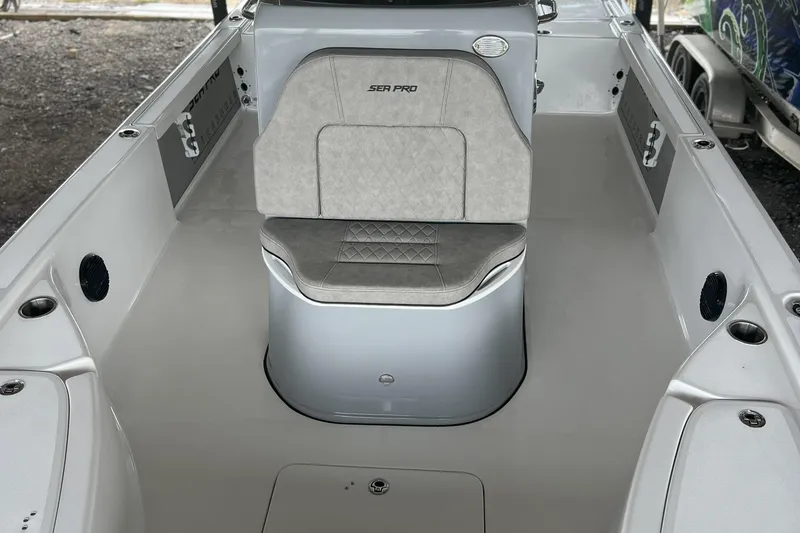 Slide: The Image of 2023 Sea Pro 248 Bay boat interior with cushioned seating and storage compartments. - 17