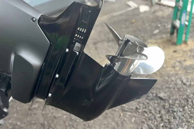 Slide: The Image of Close-up of a 2023 Sea Pro 248 Bay boat propeller on gravel surface. - 19