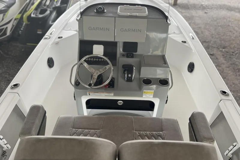 Slide: The Image of 2023 Sea Pro 248 Bay boat interior with Garmin navigation system and steering console. - 3
