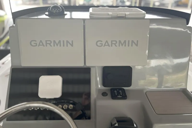 Slide: The Image of 2023 Sea Pro 248 Bay boat dashboard with dual Garmin displays. - 4