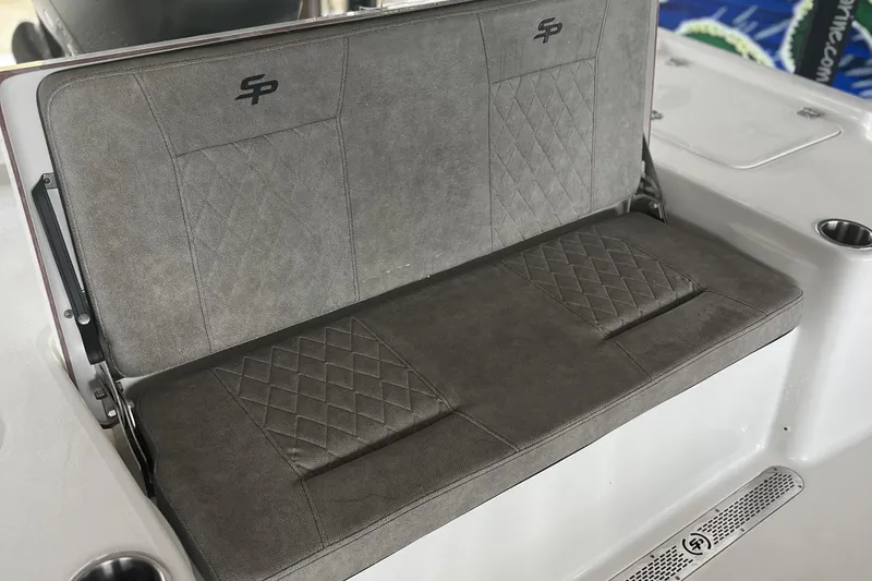 Slide: The Image of 2023 Sea Pro 248 Bay boat seat with diamond-patterned upholstery and cup holders. - 8