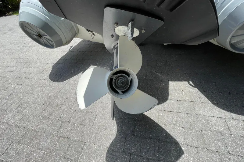Slide: The Image of Propeller of 2024 Flexboat Flex 450 on a paved surface, close-up view. - 12