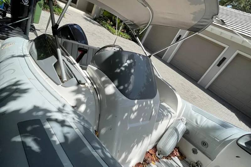 Slide: The Image of Flexboat Flex 450 inflatable boat with canopy, parked in a driveway. - 14