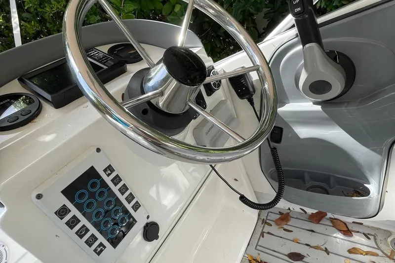 Slide: The Image of Flexboat Flex 450 control panel with steering wheel and navigation instruments. - 8