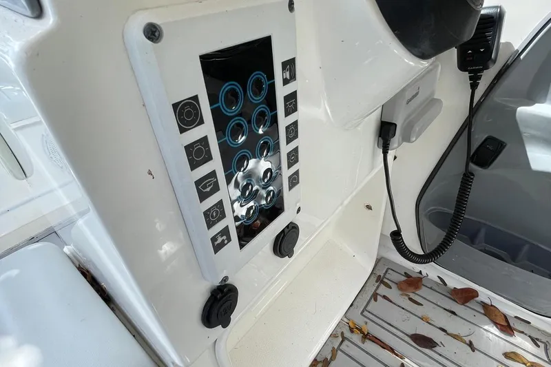 Slide: The Image of Control panel of a Flexboat Flex 450 with various switches and a microphone. - 9