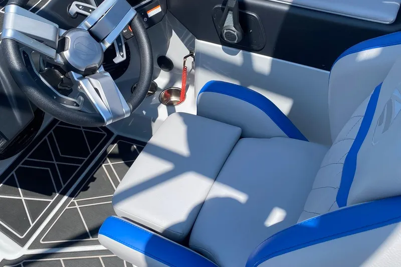 Slide: The Image of 2023 Tigé 24RZX boat interior with modern steering wheel and blue-accented seating. - 14