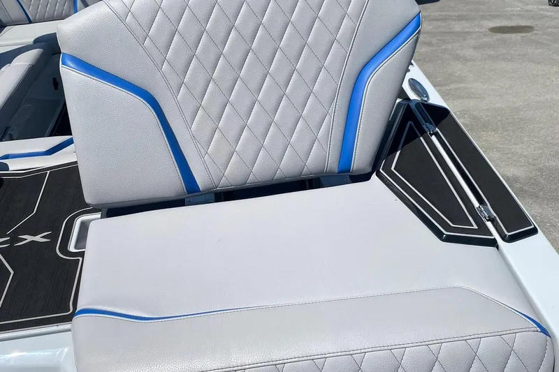 Slide: The Image of 2023 Tigé 24RZX boat seat with gray and blue accents, featuring diamond stitching. - 15