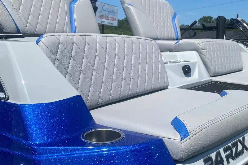 Slide: The Image of 2023 Tigé 24RZX boat with blue metallic finish and luxurious quilted seating. - 17