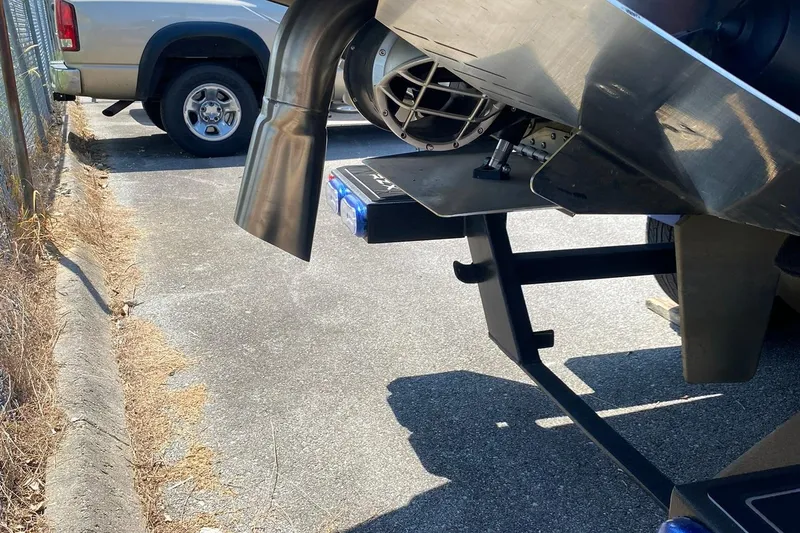 Slide: The Image of Rear view of 2023 Tigé 24RZX boat with exhaust and propeller details. - 5