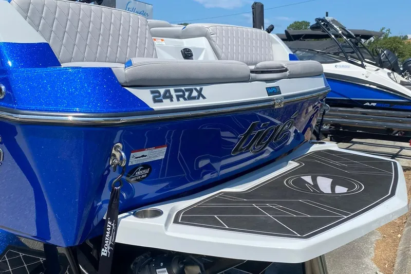 Slide: The Image of 2023 Tigé 24RZX boat with blue exterior and sleek design, featuring comfortable seating. - 6