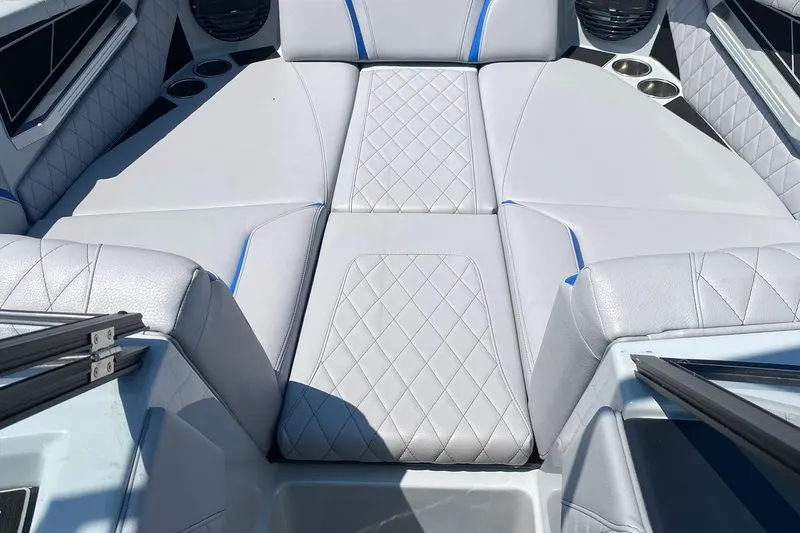 Slide: The Image of 2023 Tigé 24RZX boat interior with luxurious white seating and blue accents. - 9