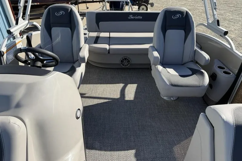 Slide: The Image of 2025 Barletta A20UC boat interior with gray seating and steering wheel. - 18