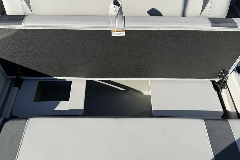 Slide: The Image of 2025 Barletta A20UC boat seat storage compartment, open with visible interior space. - 19