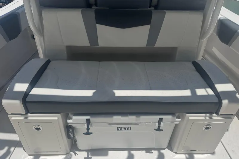 Slide: The Image of 2025 Robalo R300 Center Console boat seat with Yeti cooler storage. - 10