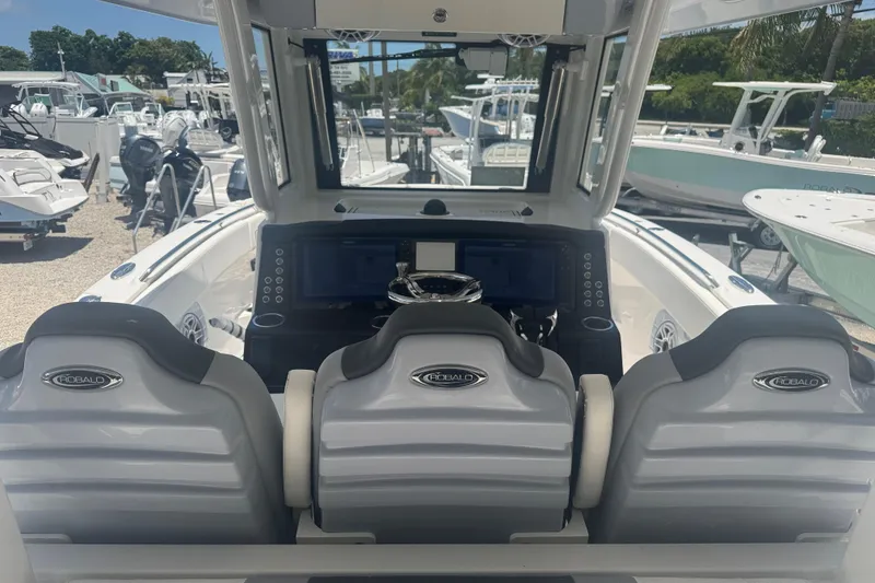 Slide: The Image of 2025 Robalo R300 Center Console boat interior with modern dashboard and seating. - 11