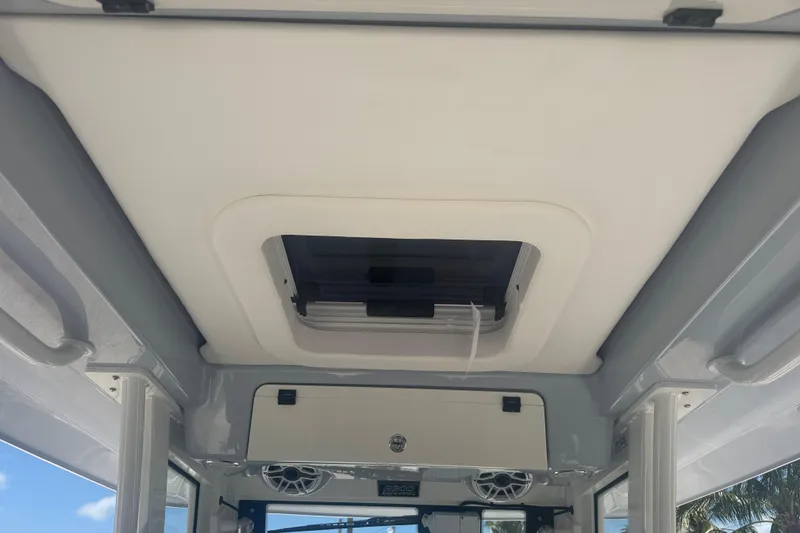 Slide: The Image of 2025 Robalo R300 Center Console boat interior ceiling with hatch and speakers. - 13
