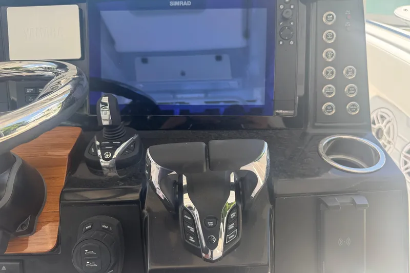 Slide: The Image of 2025 Robalo R300 Center Console dashboard with steering wheel and control panel. - 14