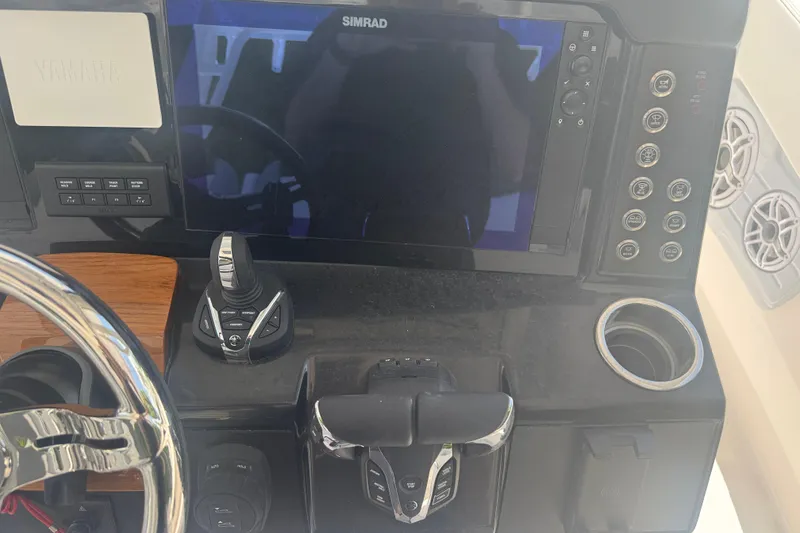 Slide: The Image of 2025 Robalo R300 Center Console dashboard with Simrad display and controls. - 19