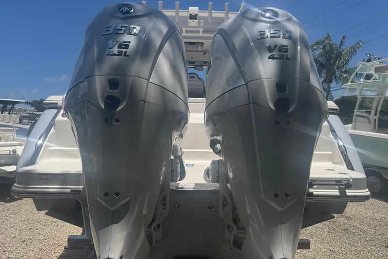 Slide: The Image of 2025 Robalo R300 Center Console with dual Yamaha 350 V6 outboard engines. - 2