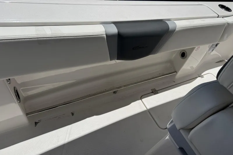 Slide: The Image of 2025 Robalo R300 Center Console boat interior, featuring sleek seating and storage area. - 22