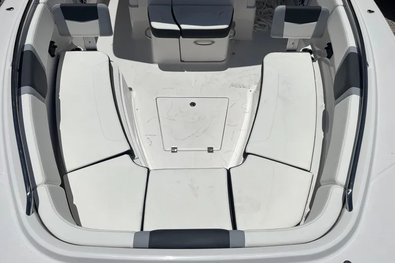 Slide: The Image of 2025 Robalo R300 Center Console boat interior with cushioned seating and storage compartments. - 27