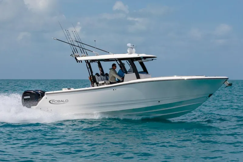 Slide: The Image of Manufacturer Provided Image: 2025 Robalo R300 Center Console boat cruising on open water. - 31