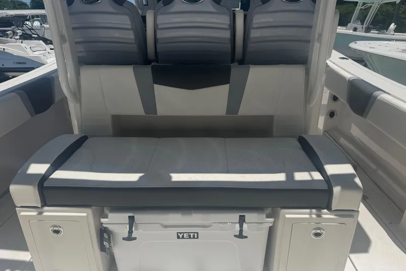 Slide: The Image of 2025 Robalo R300 Center Console boat seating with Yeti cooler storage. - 6