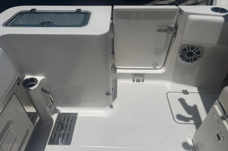 Slide: The Image of 2025 Robalo R300 Center Console boat interior with storage and speaker. - 7