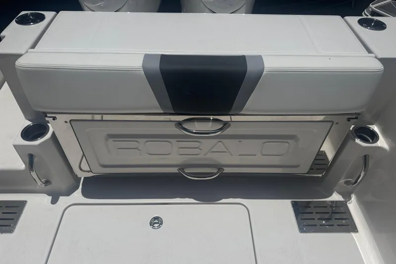 Slide: The Image of 2025 Robalo R300 Center Console boat seating with integrated storage and cup holders. - 9