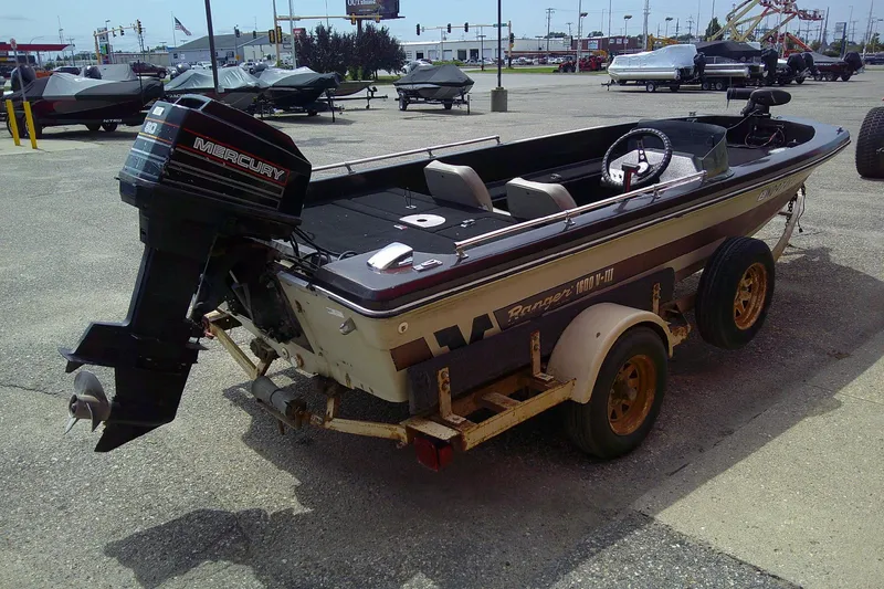 Slide: The Image of 1981 Ranger 1600 V-III boat with Mercury outboard motor on trailer in parking lot. - 4
