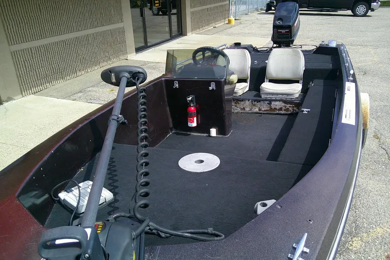 Slide: The Image of 1981 Ranger 1600 V-III boat interior with steering wheel, seats, and motor. - 7