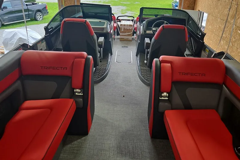 Slide: The Image of Interior of 2025 Trifecta Sport RF9 DC boat with red and gray seating. - 13