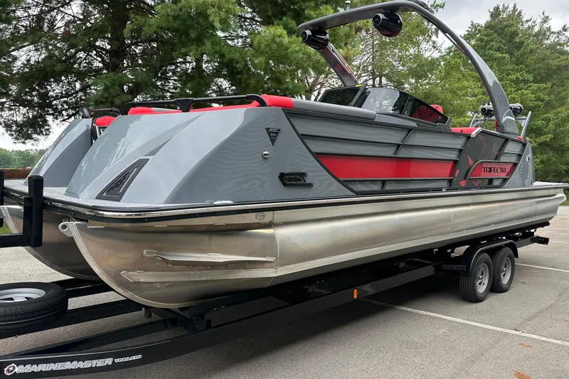 Slide: The Image of 2025 Trifecta Sport RF9 DC pontoon boat on trailer, featuring sleek design and vibrant accents. - 4