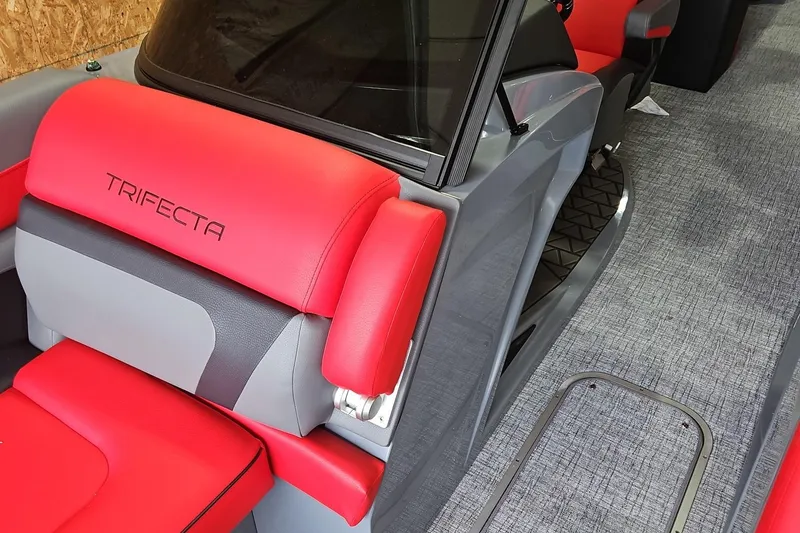Slide: The Image of 2025 Trifecta Sport RF9 DC boat interior with red and gray seating. - 7