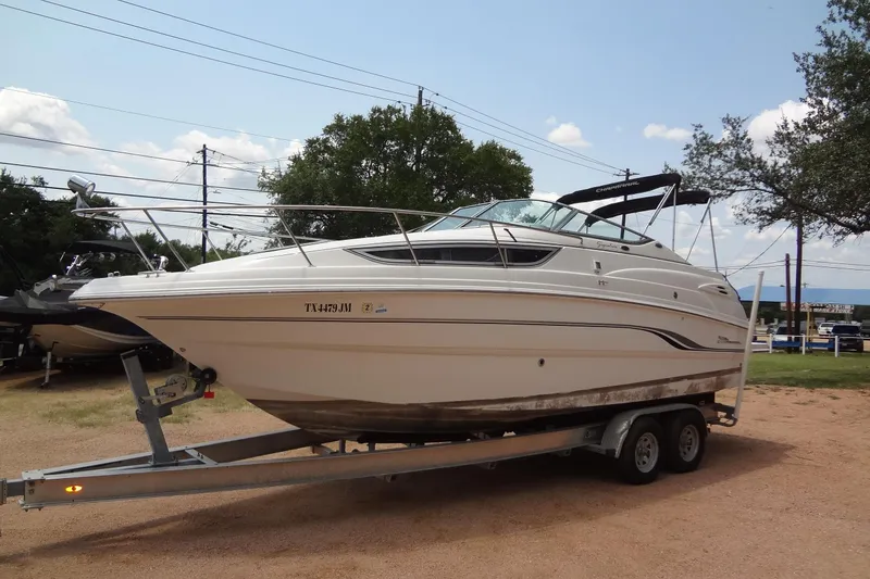 Slide: The Image of 2000 Chaparral Signature 260 boat on trailer, parked outdoors. - 1